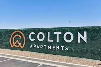 a green wall with a sign for cotton apartments